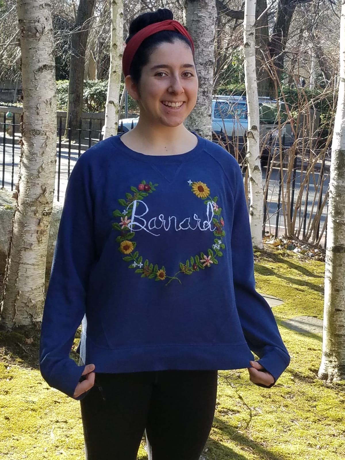 Picture of Miranda in the navy sweatshirt from Target on which she embroidered a floral take of the Barnard logo